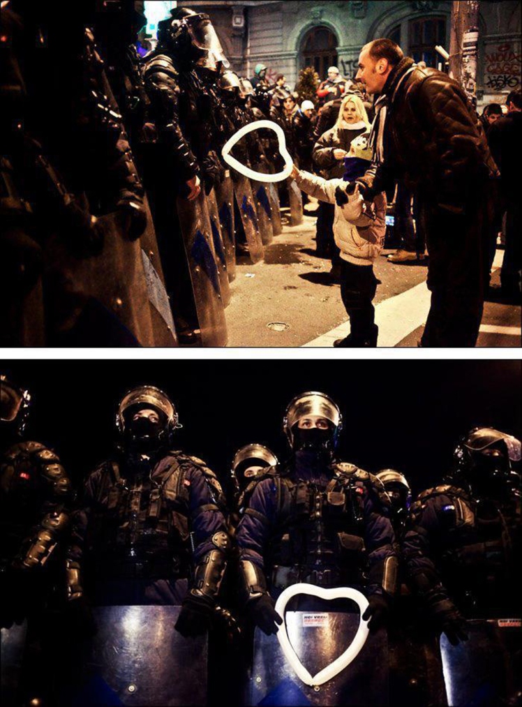 a-romanian-child-hands-a-heart-shaped-balloon-to-riot-police-during-protests-against-austerity-measures-in-bucharest
